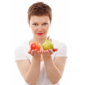 young girl showing fruits